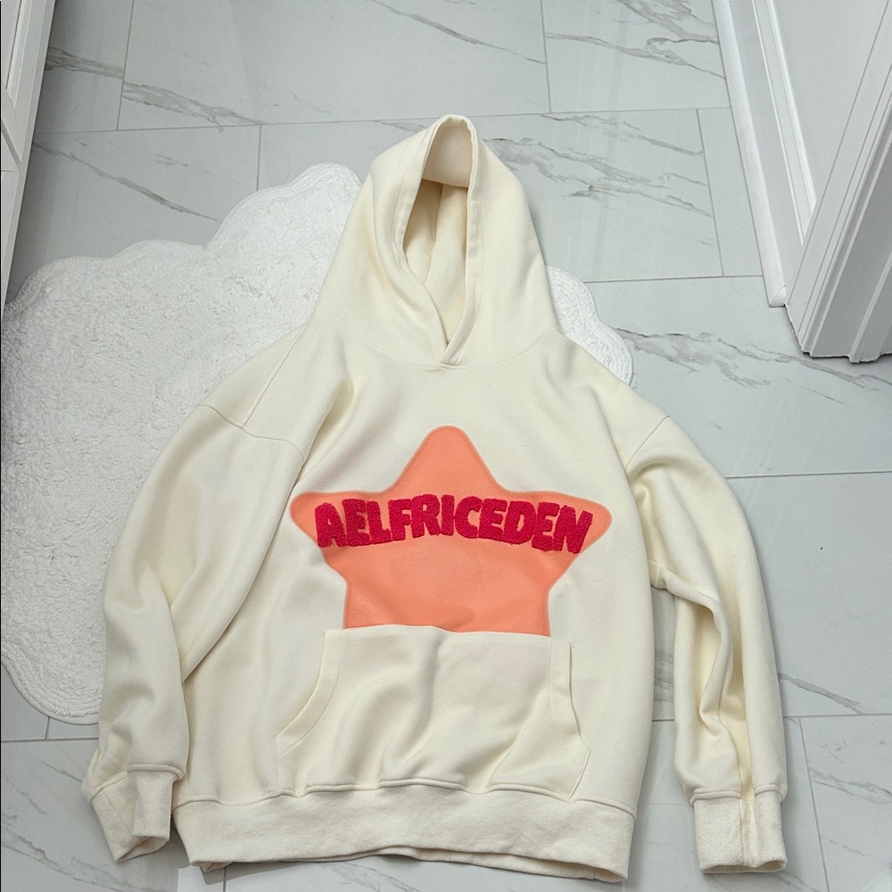 Aelfric Eden Cream Hoodie with Orange Star and Red Text